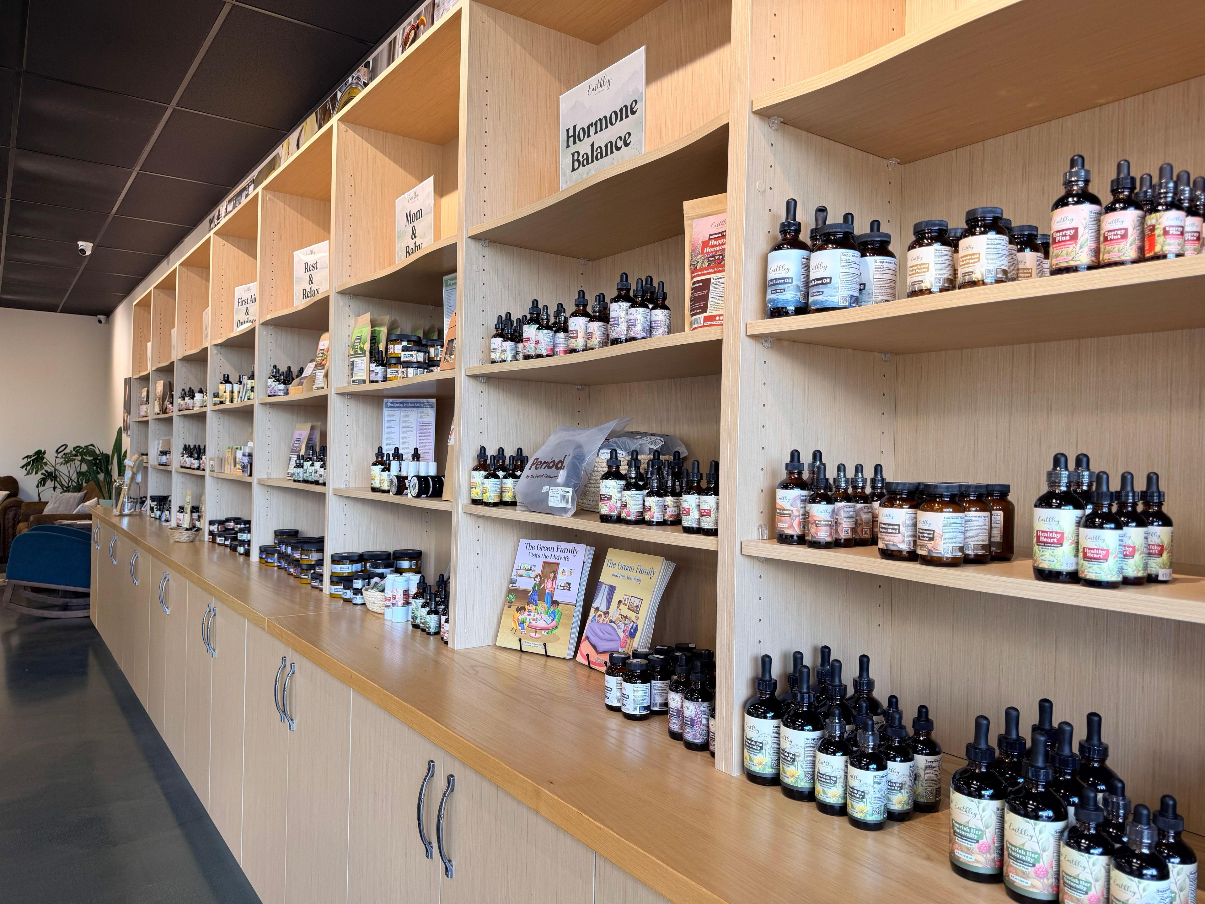 Earthley Wellness retail store shelves displaying herbal tinctures organized by health category