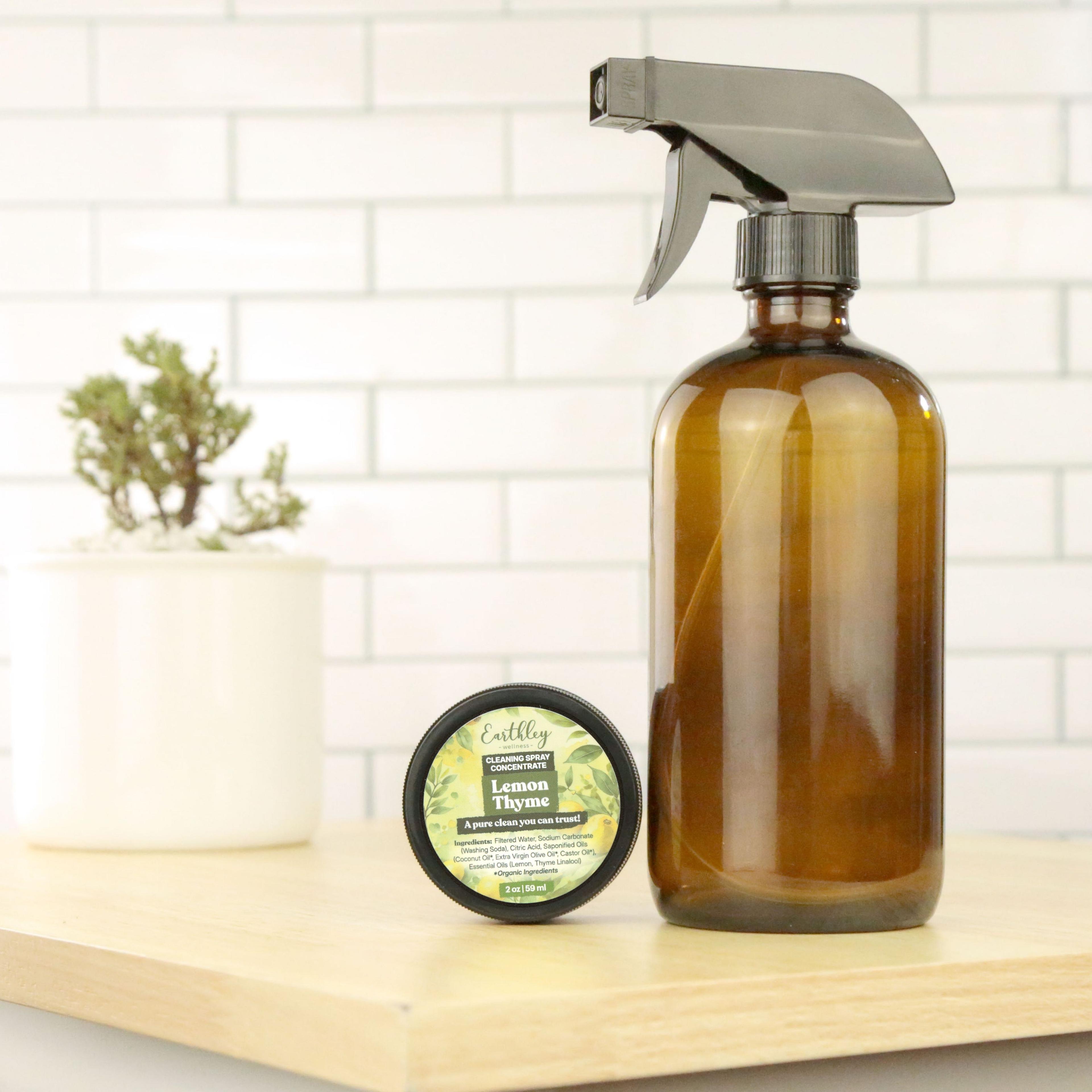 Earthley Lemon Thyme Cleaning Spray Concentrate jar beside amber glass spray bottle