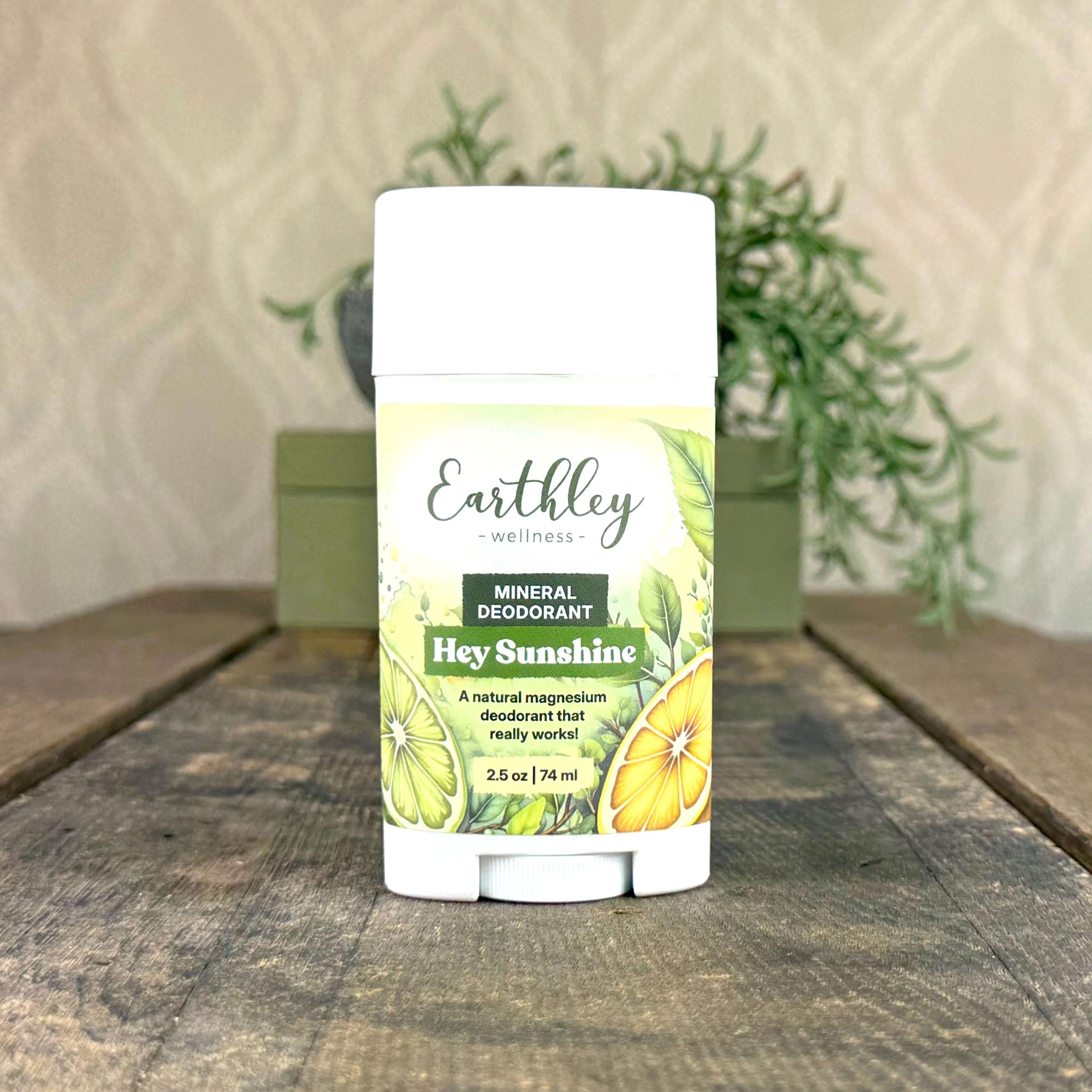 Earthley Wellness Hey Sunshine natural magnesium deodorant stick with citrus and botanical label design on rustic wood surface