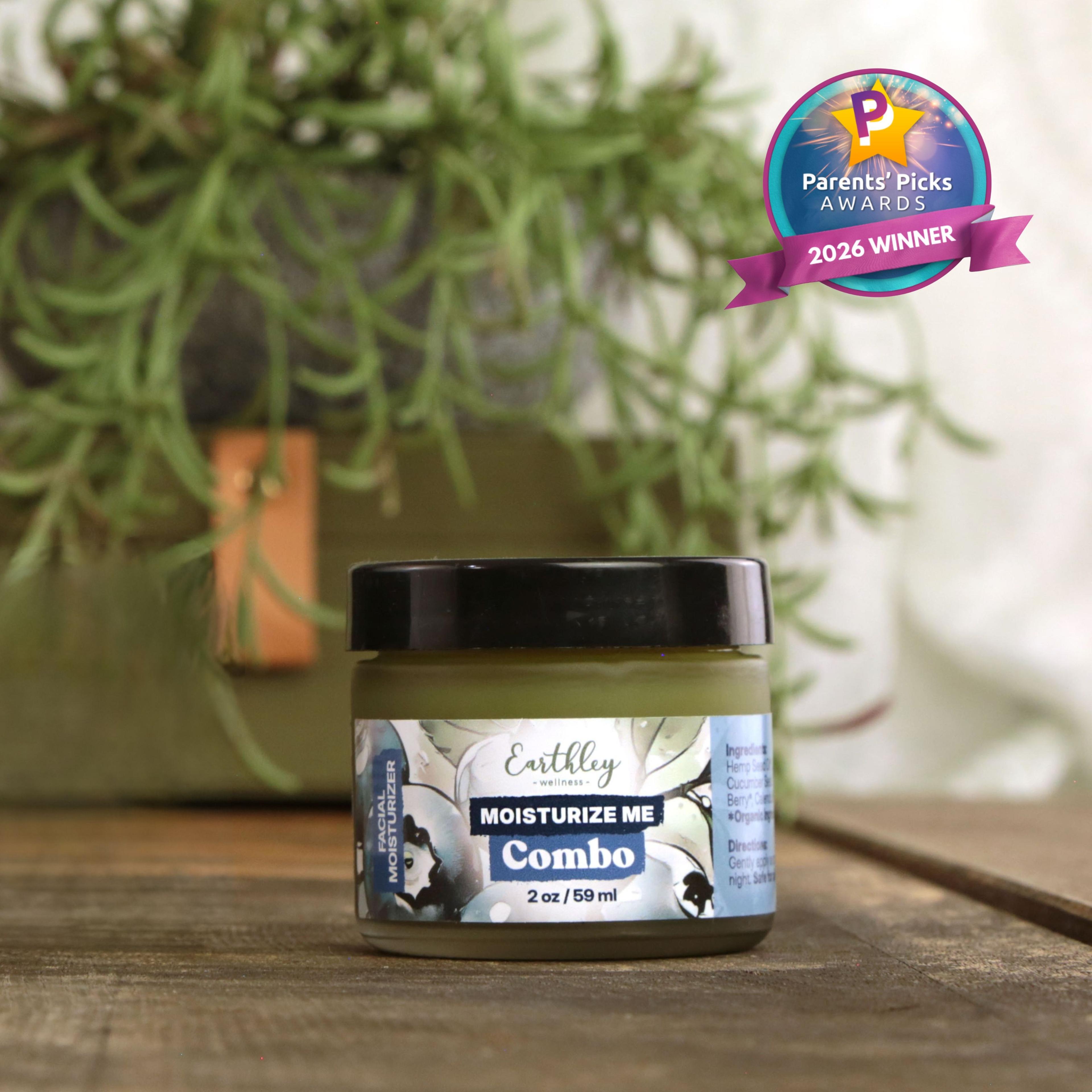 Earthley Moisturize Me Combo salve jar with Parents' Picks Awards 2026 Winner badge, displayed with green plants