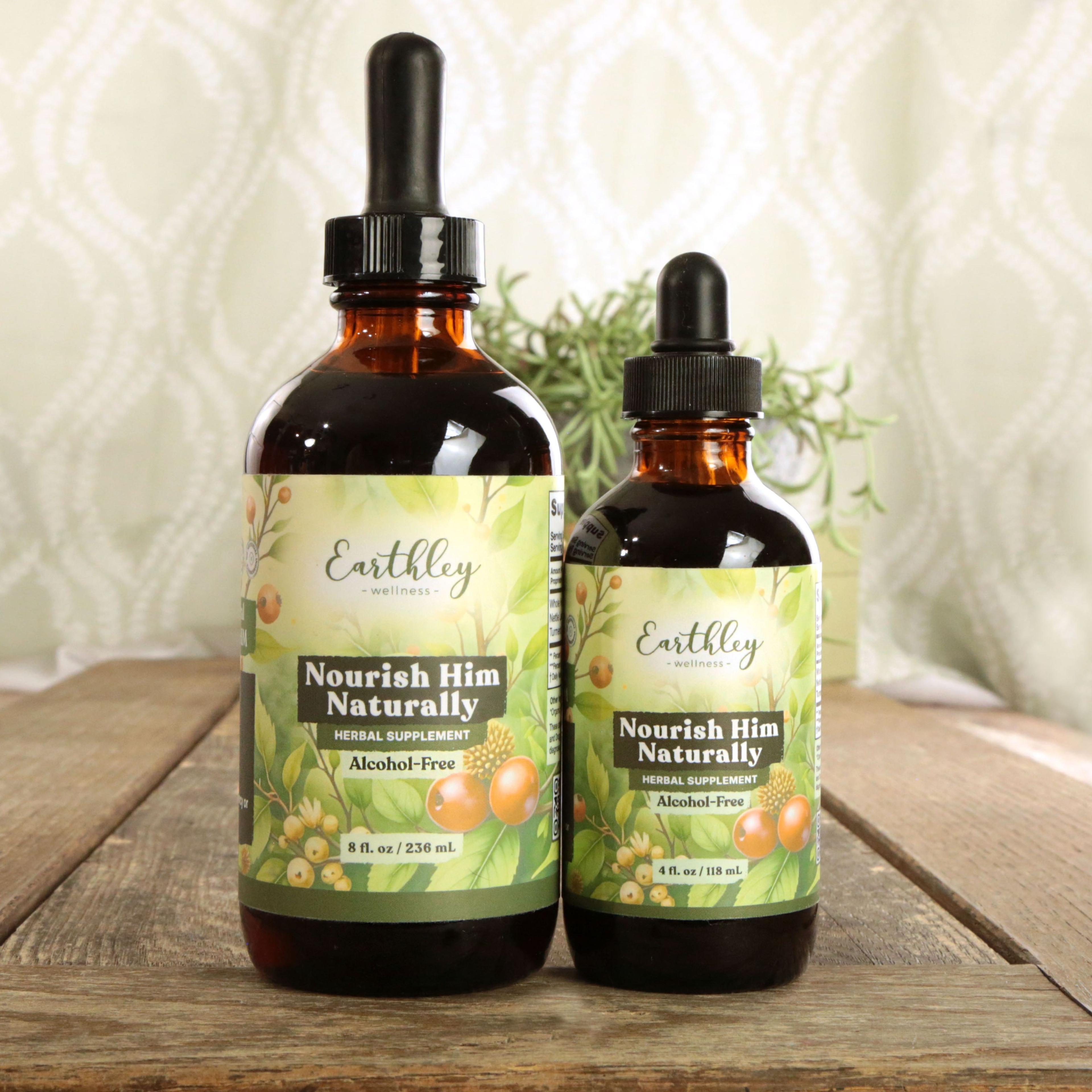 Earthley Nourish Him Naturally Alcohol-Free amber dropper bottles in two sizes 8 oz and 4 oz with sage green botanical berry labels on rustic wood surface with potted succulent plant in background