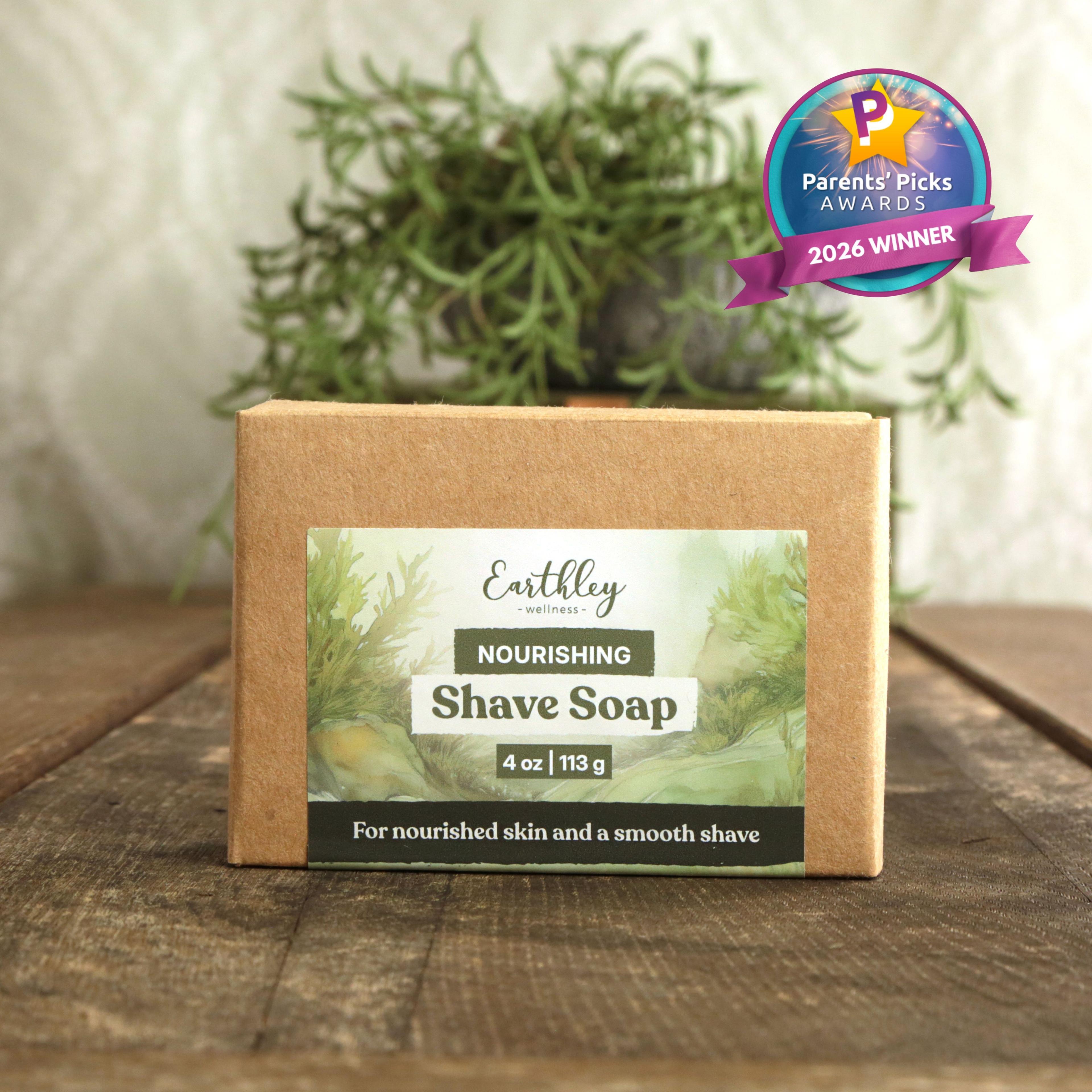 Earthley Wellness Nourishing Shave Soap bar on wooden surface with green plant background, featuring Parents' Picks 2026 Winner badge