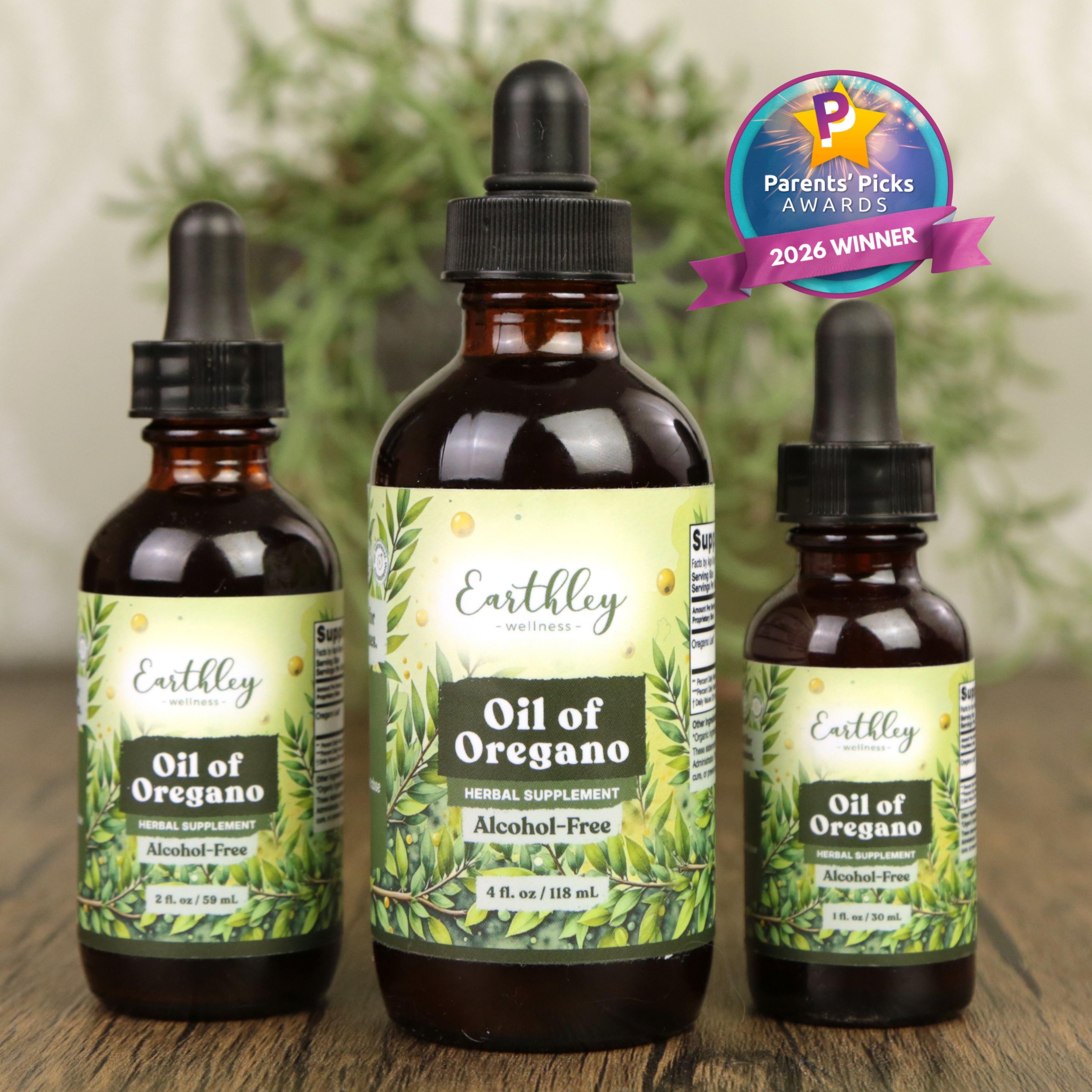Three amber glass bottles of Earthley Oil of Oregano tinctures in different sizes with dropper caps and botanical labels, featuring Parents' Picks ...