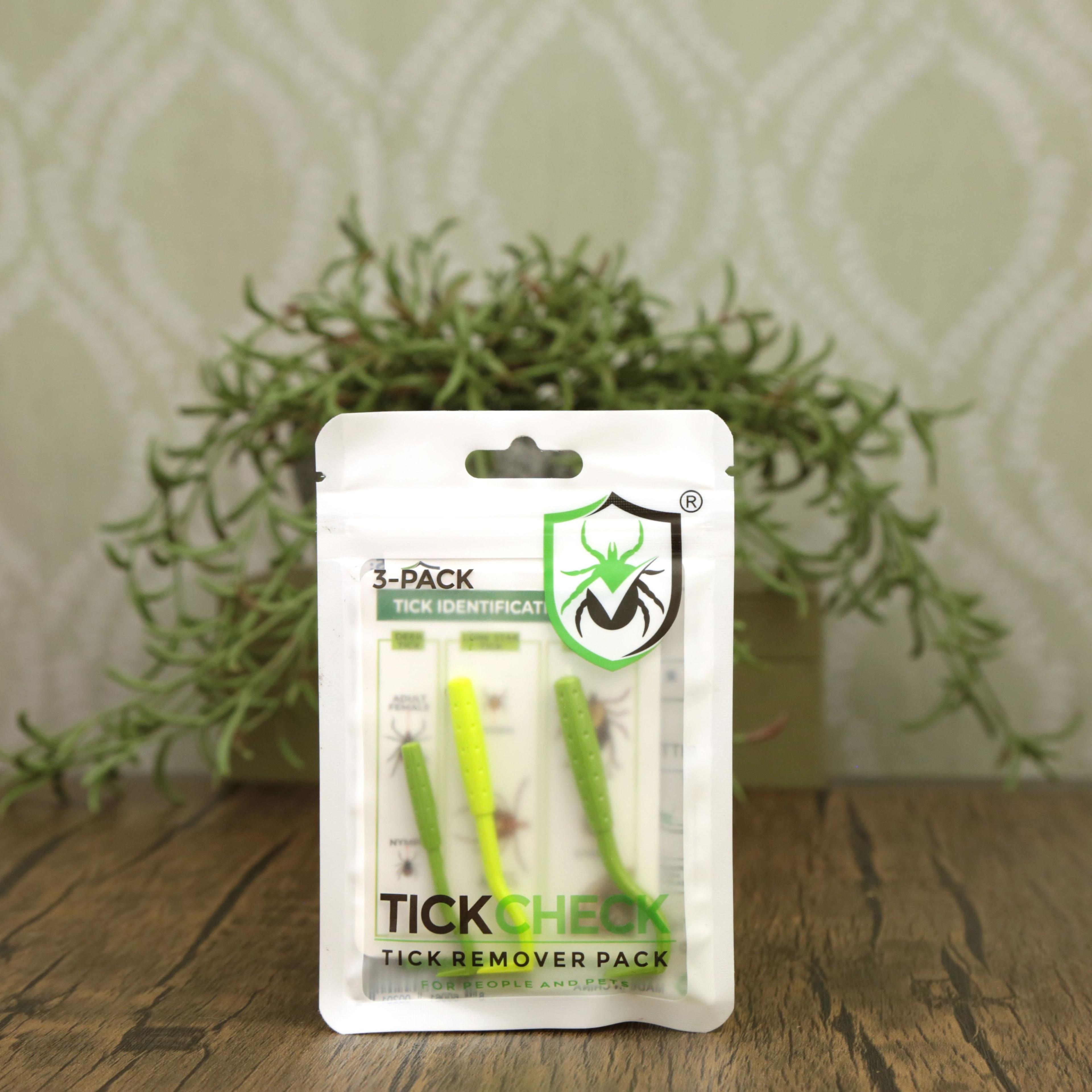 TickCheck 3-pack tick identification and removal tools in white package with green tweezers on wooden surface