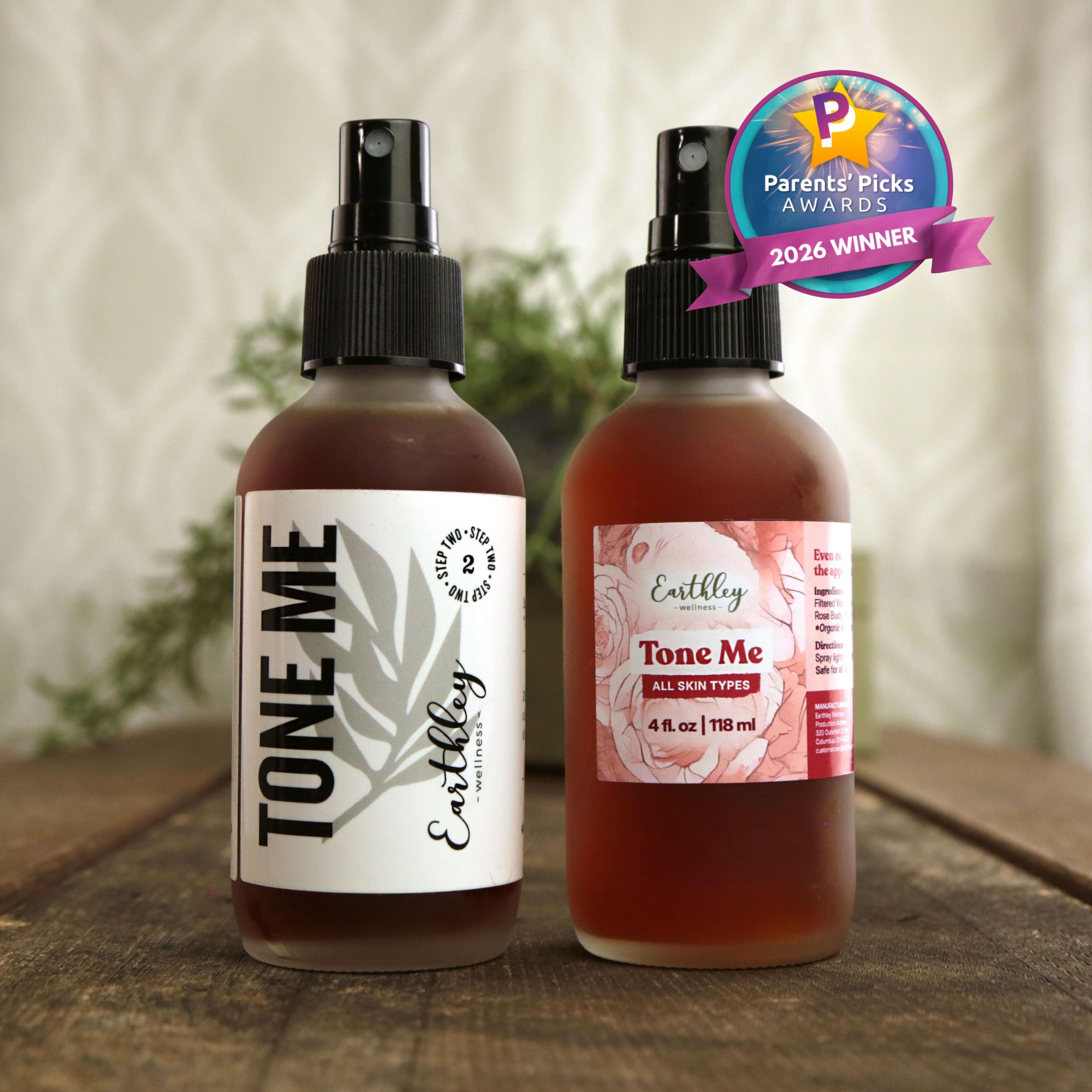Two amber glass spray bottles of Earthley Tone Me facial toner on wooden surface with Parents' Picks 2026 Winner award badge