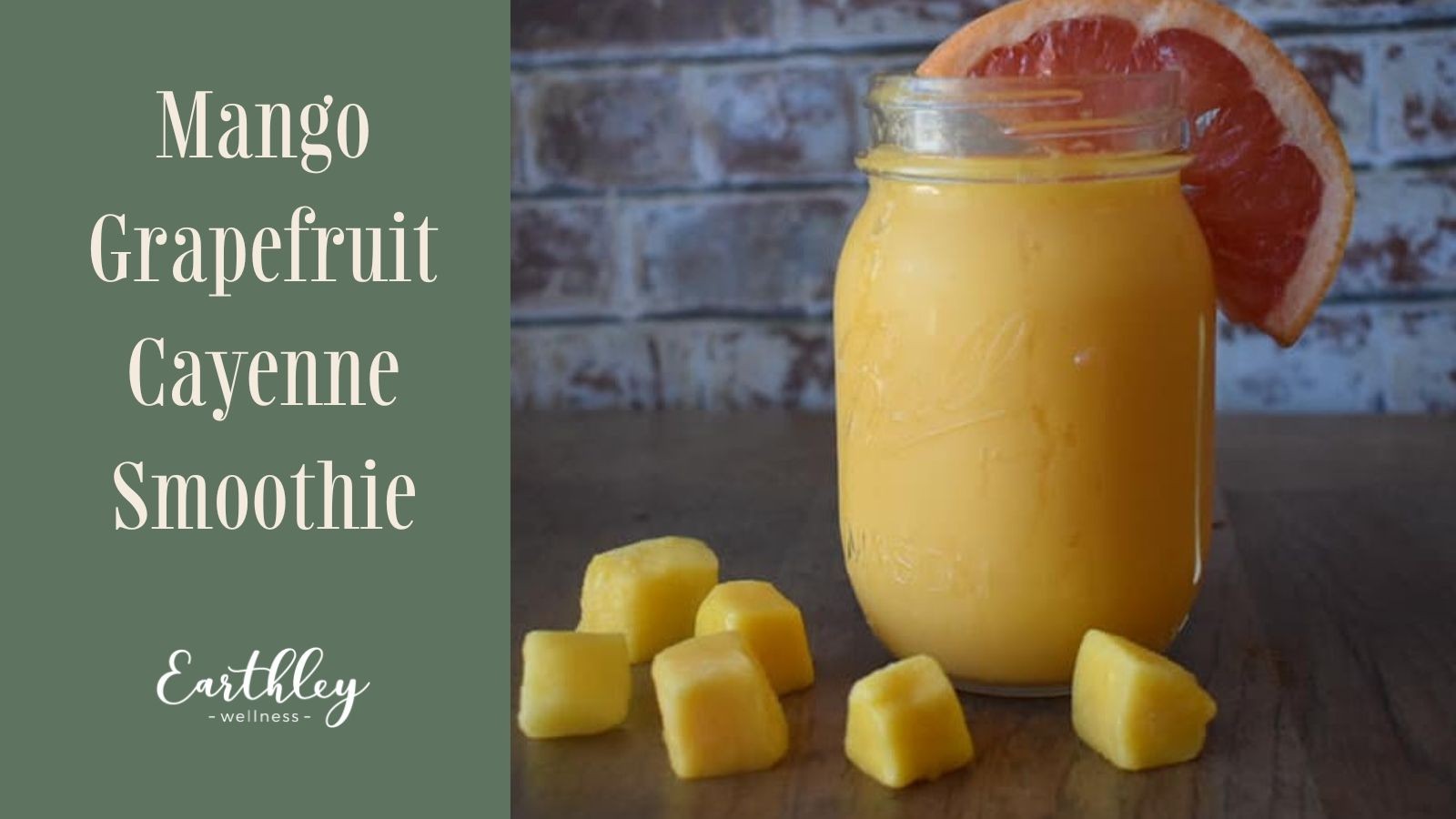 Mango Grapefruit Cayenne Smoothie recipe header showing clear glass mason jar with bright yellow orange smoothie pink grapefruit slice garnish and yellow mango chunks on dark brown wooden table with white gray brick wall background and sage green text panel