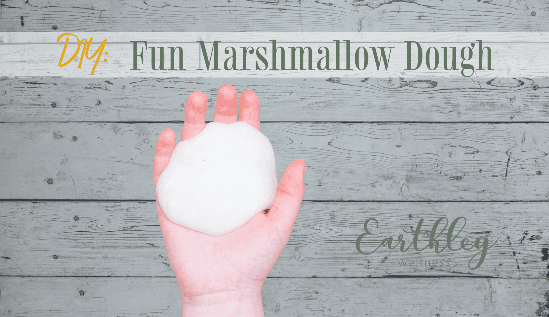 DIY Fun Marshmallow Dough recipe showing hand holding round white marshmallow dough ball against gray weathered wooden plank background