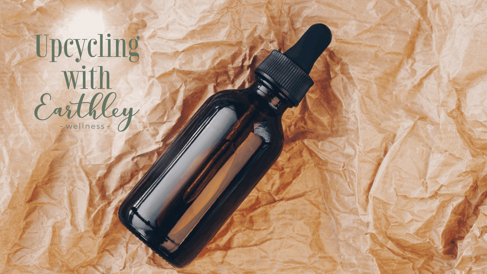 Upcycling with Earthley guide header showing dark amber glass dropper bottle with black cap on crinkled brown kraft paper background